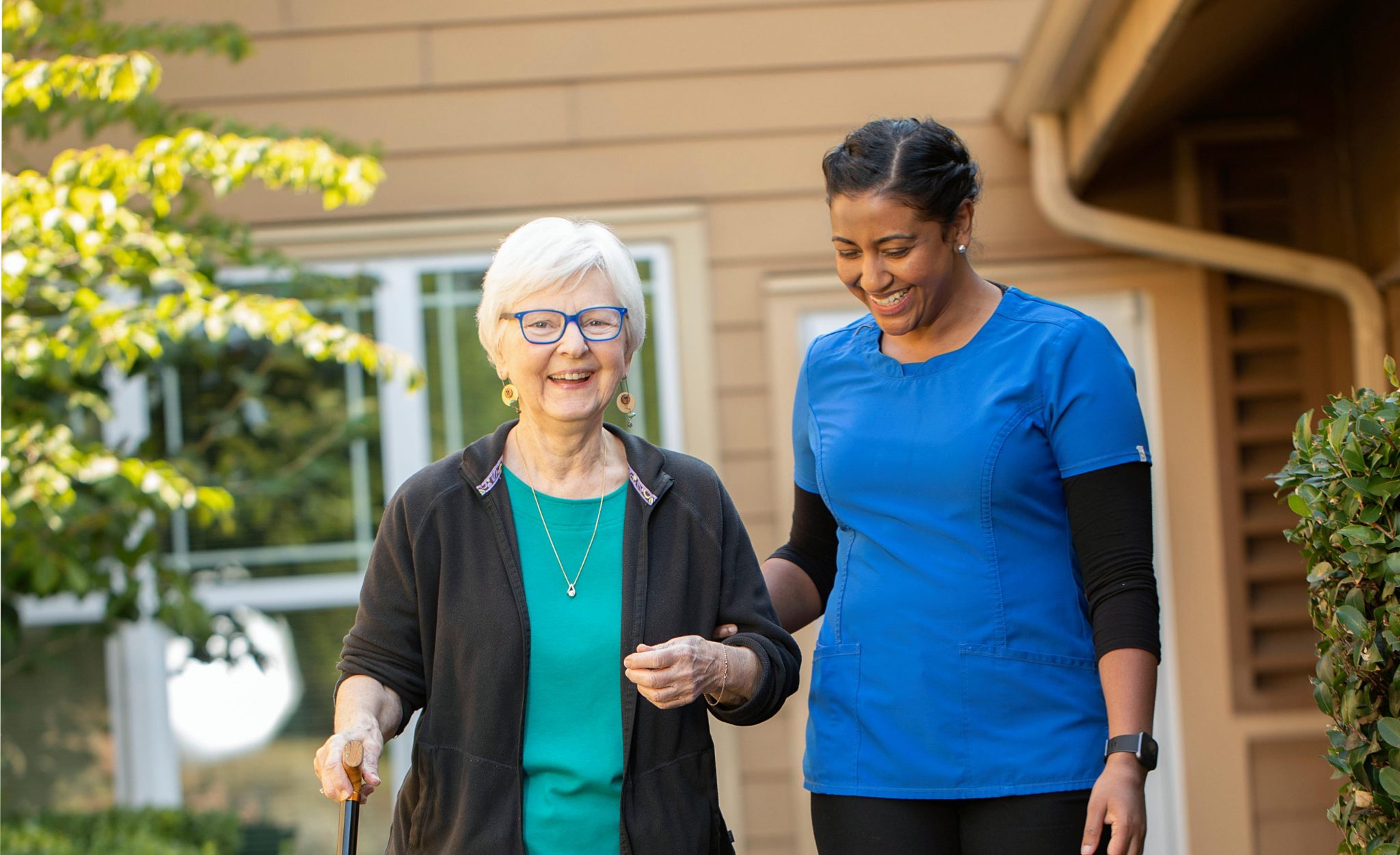 caregiver walking with resident