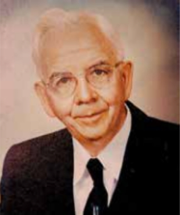 headshot of dr stanley logan in a black suit and tie