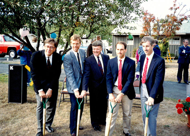 men in suit and ties breaking ground for new building at wesley 