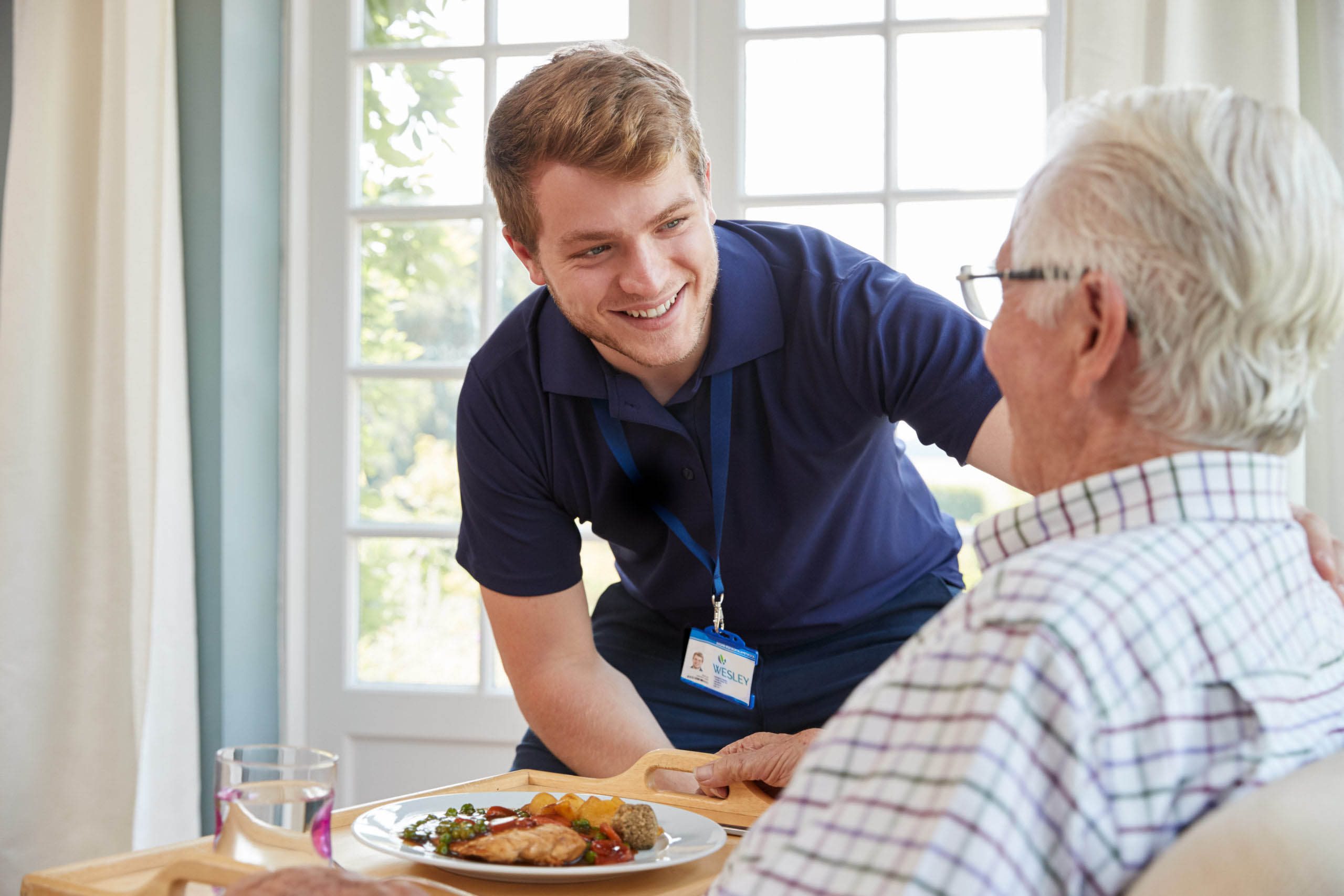 Caregiver helping senior with meal prep