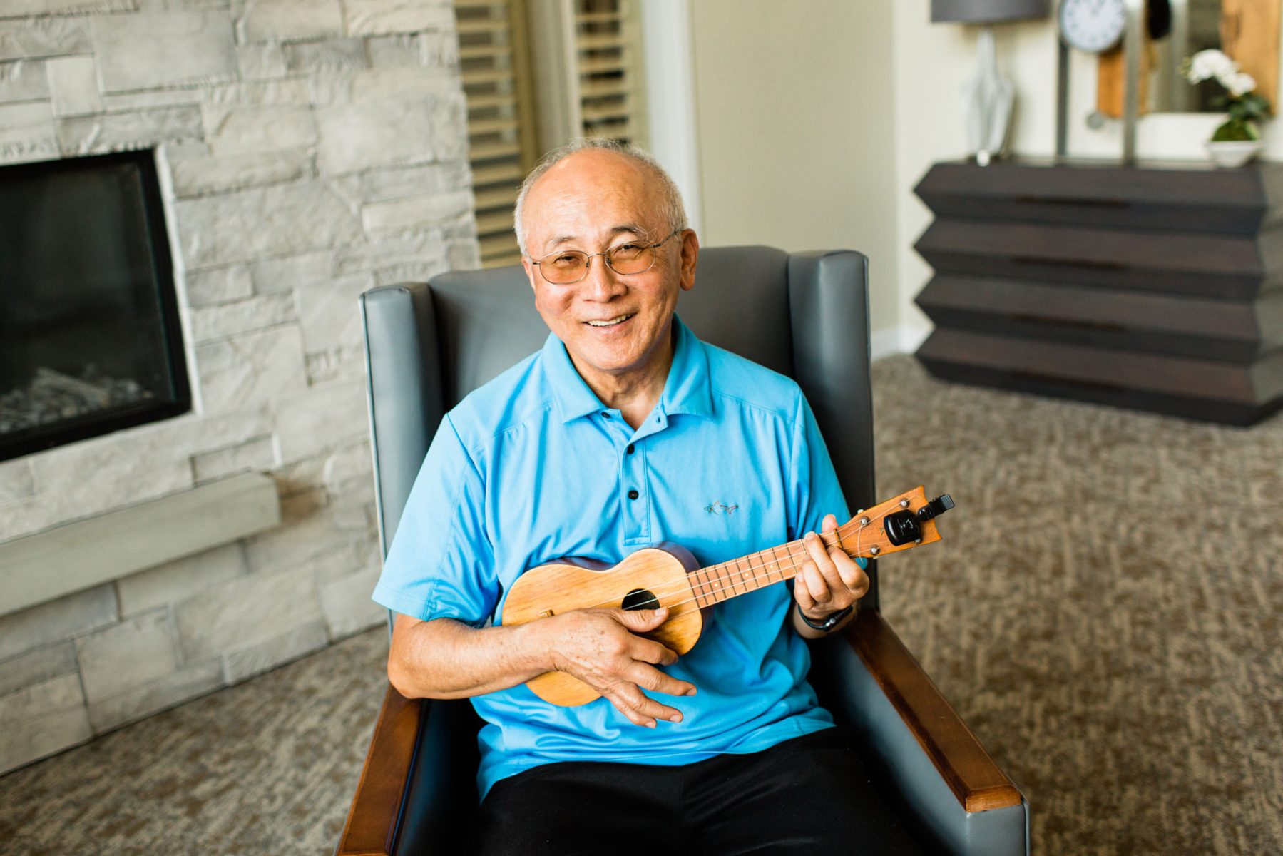 Happy man playing an ukulele