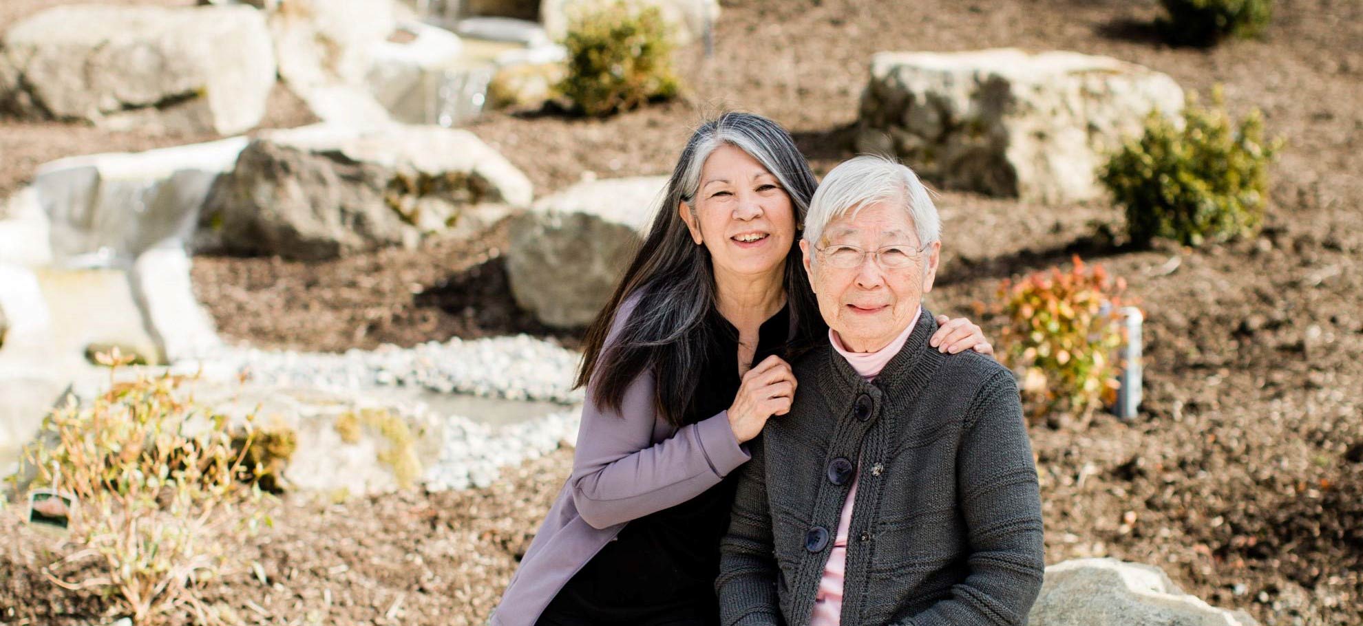 Ellen and Anna Hasegawa near the waterfall in the Anna and Harry Hasegawa Meditation Garden