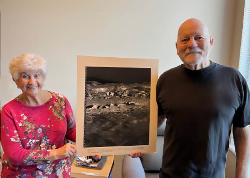 Bill and Judy Norberg Holding Photo of Moon