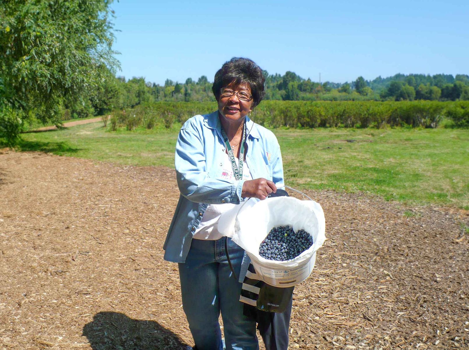 Wesley Resident Blueberry picking showing bucket