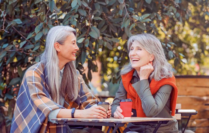 happy older women enjoying coffee together