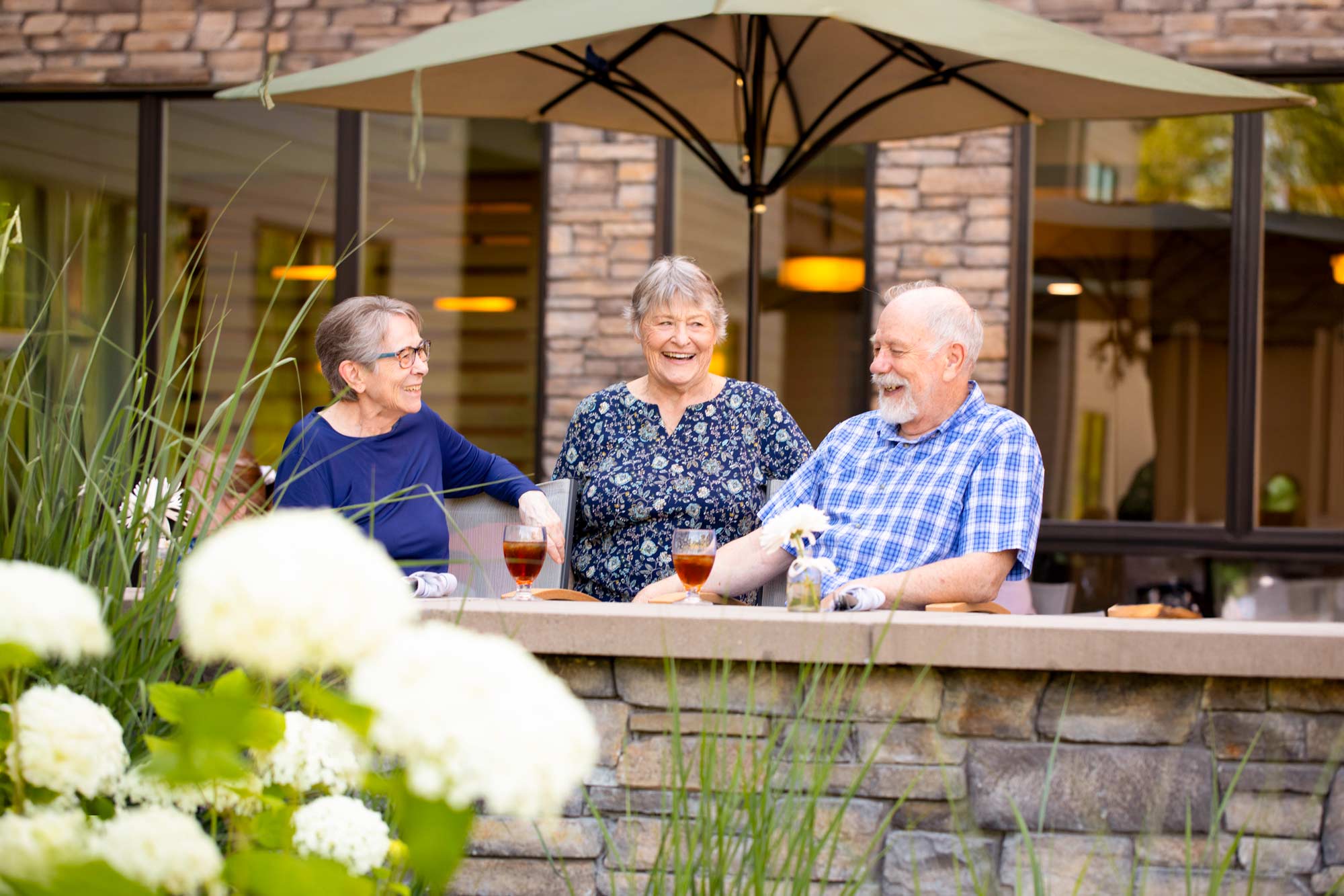 happy-group-of-older-adults-enjoying-drinks-outside