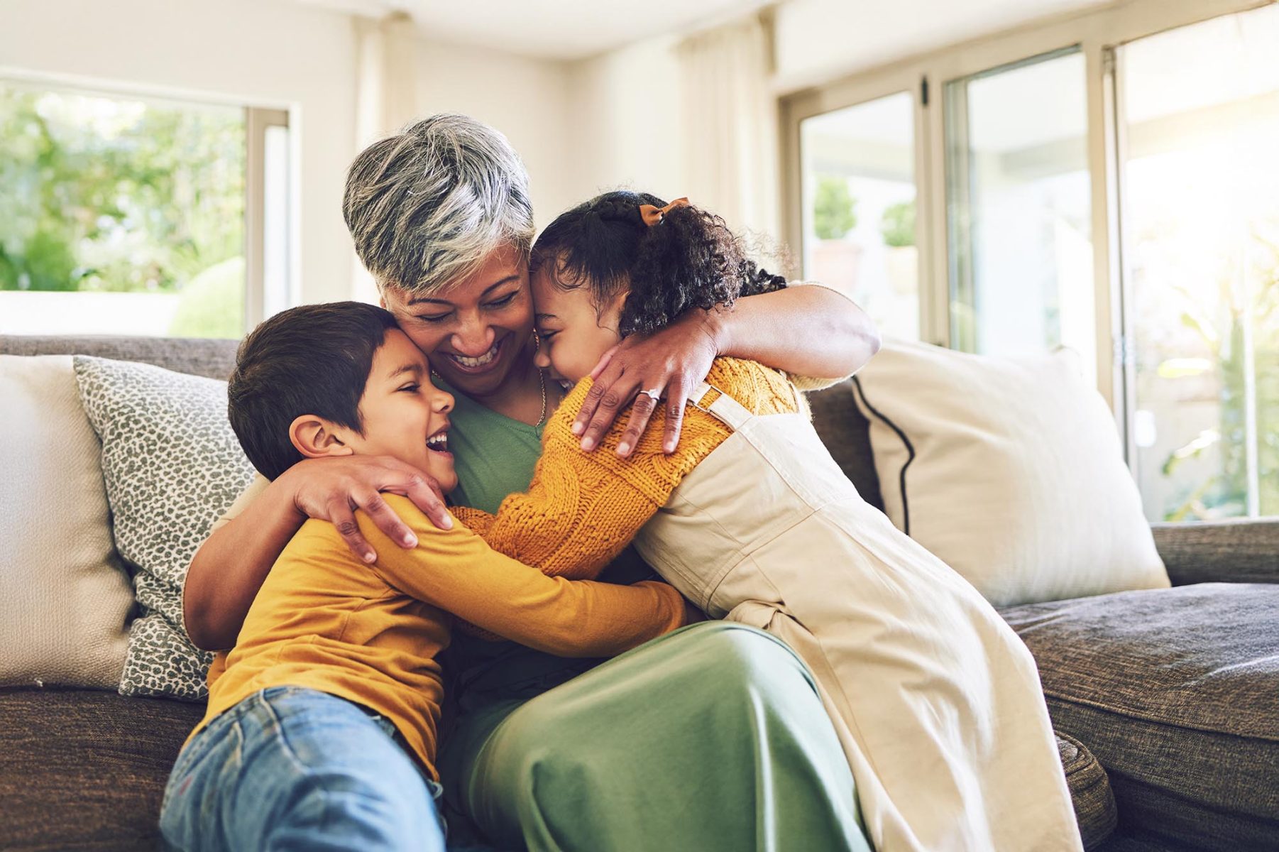 children happy hugging with grandparent senior woman