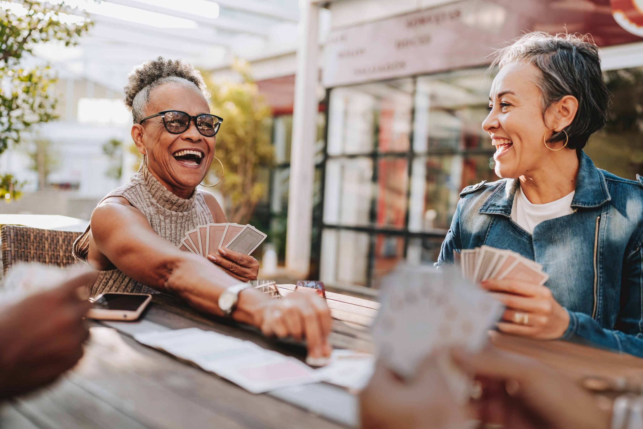 older women enjoying a card game outdoors